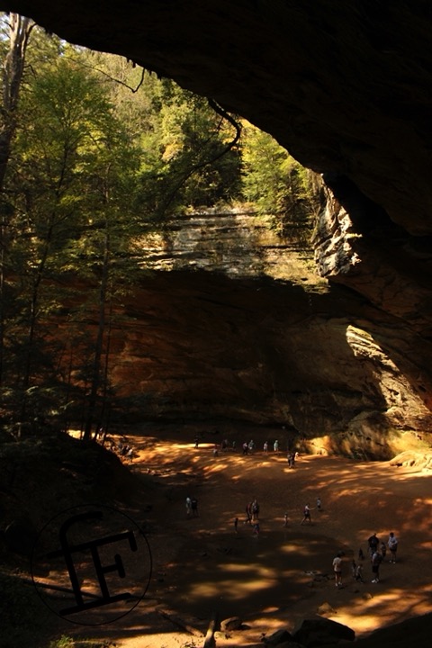 an overhanging cliff forming a cave.